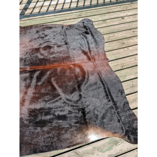 T16 78 x 64 large cowhide rug featuring natural irregular shape with dark brown to black and reddish angus oliver fur