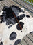 Large black and white cowhide rug with natural fur texture perfect for stylish home decor angus oliver