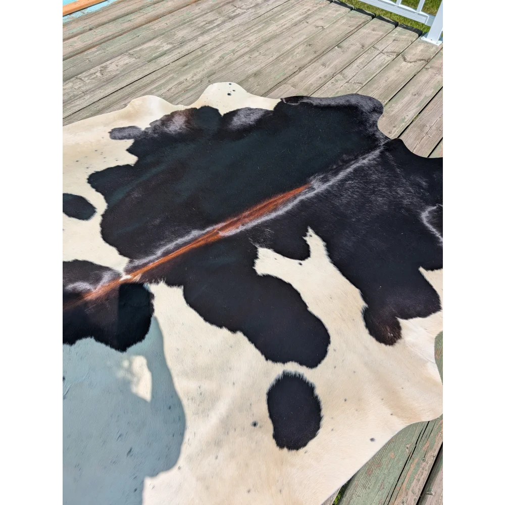 Large cowhide rug angus oliver with black and cream natural irregular pattern measuring 77 by 66 inches