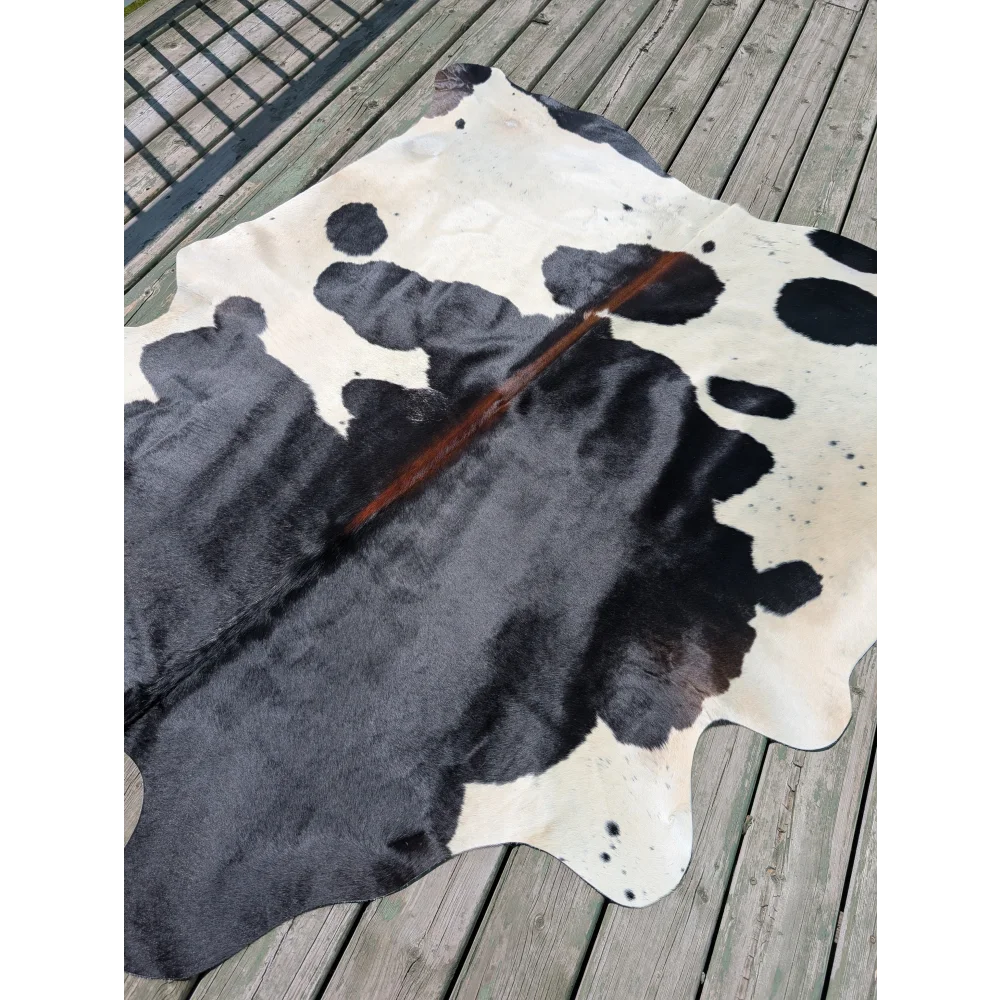 Large black and white cowhide rug with natural fur texture angus oliver perfect for stylish home decor