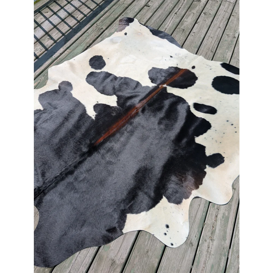 Large black and white cowhide rug with natural fur texture angus oliver perfect for stylish home decor