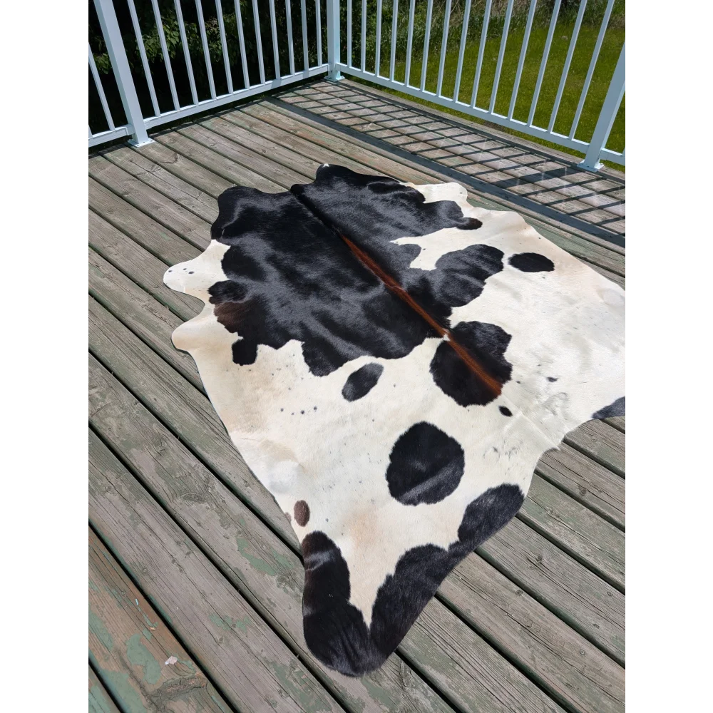 Black and white large cowhide rug with natural fur texture perfect for stylish home decor angus oliver t17