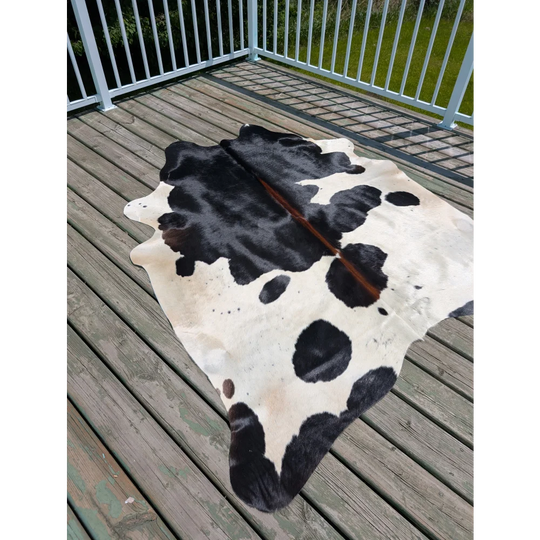 Black and white large cowhide rug with natural fur texture perfect for stylish home decor angus oliver t17