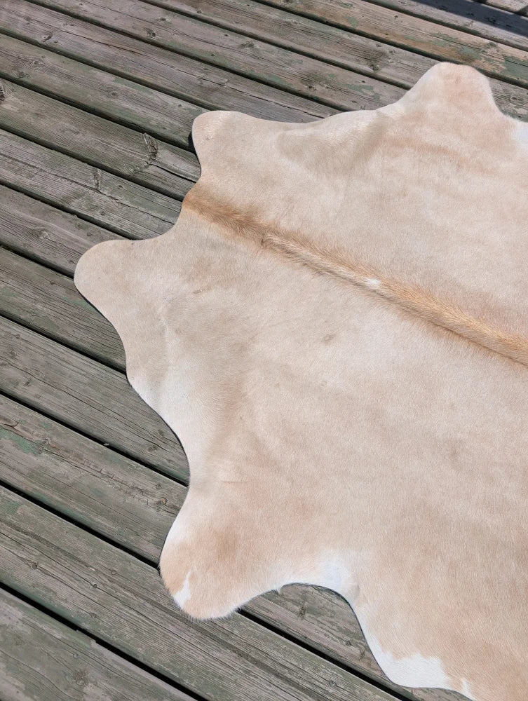 T18 77 x 63 beautiful large cowhide rug in natural tan with soft texture and subtle white patches by angus oliver