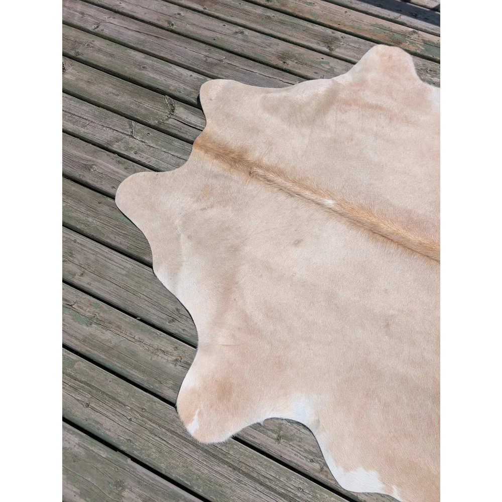 T18 77 x 63 beautiful large cowhide rug in natural tan with soft texture and subtle white patches by angus oliver