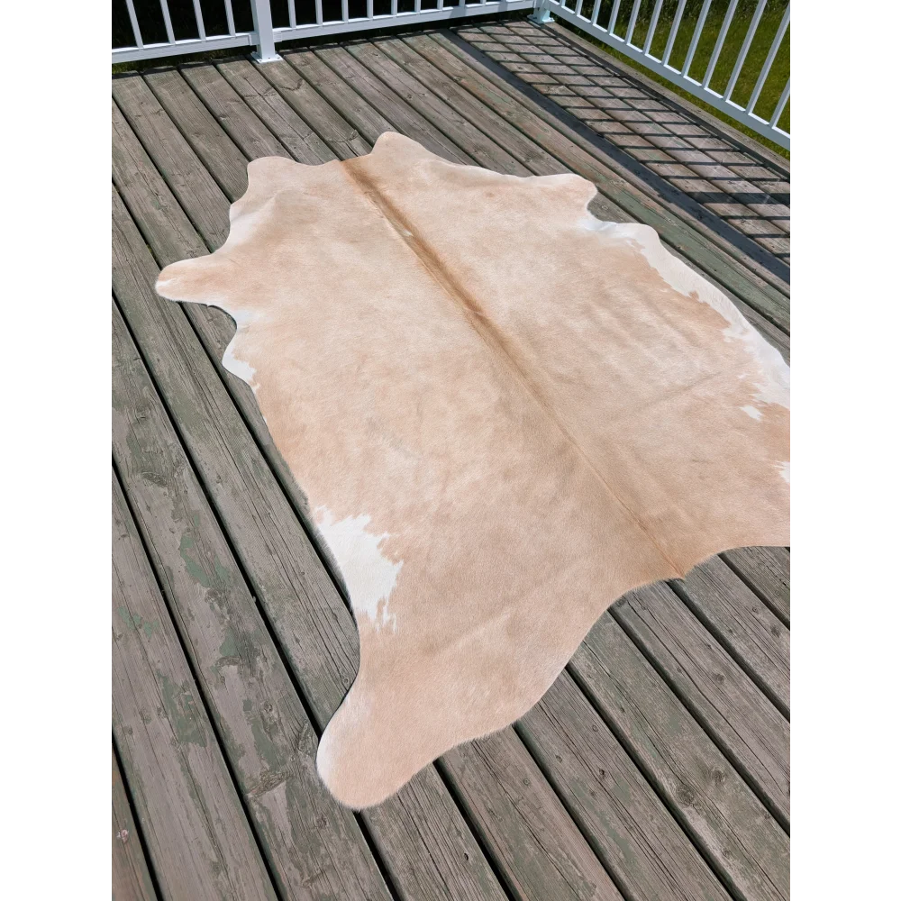 Beige and white large cowhide rug with natural irregular edges from angus oliver perfect for stylish spaces