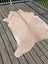 Beige and white large cowhide rug with natural irregular edges from angus oliver perfect for stylish spaces