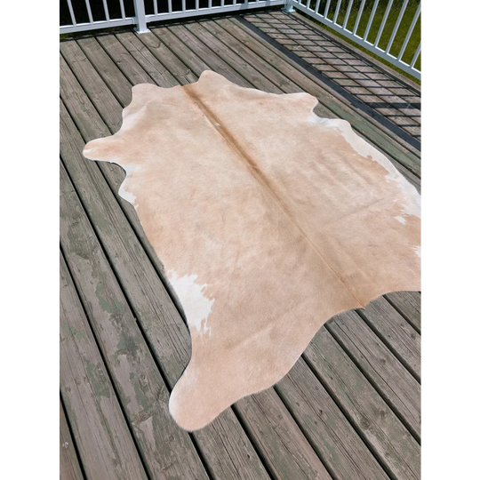 Beige and white large cowhide rug with natural irregular edges from angus oliver perfect for stylish spaces