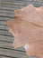 Tan large cowhide rug with natural fur texture and irregular edges perfect for angus oliver style decor