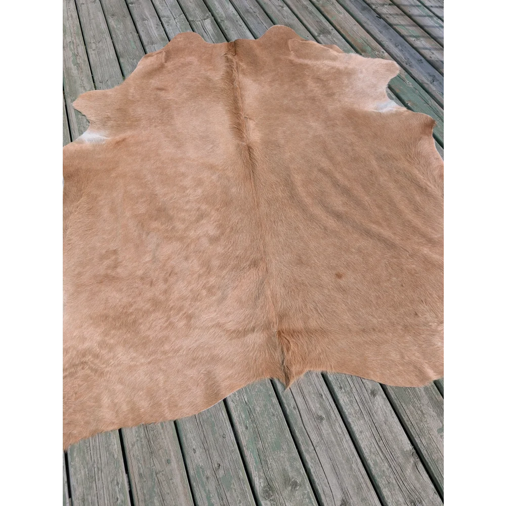 Tan large cowhide rug with natural texture and irregular edges angus oliver t19 78 x 64 gorgeous cowhide