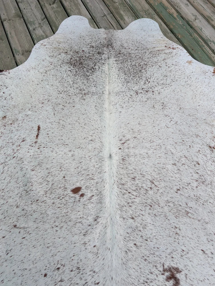 T#2 large cowhide rug 73 x 63 with white and natural brown speckles and unique central fur stripe