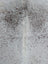 Large gray and white speckled cowhide rug with unique characteristics and natural fur texture in 73 x 63 size
