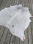 T#2 heart 73 x 63 gorgeous large cowhide rug with brown speckles and natural edges on a wooden deck showing unique characteristics