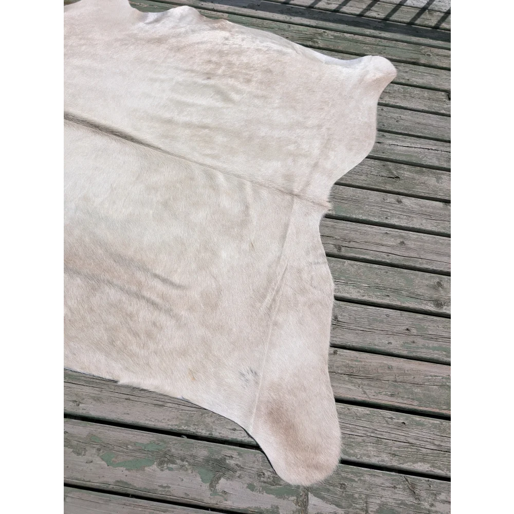 Large cowhide rug in soft off-white and beige tones perfect for stylish home decor by angus oliver