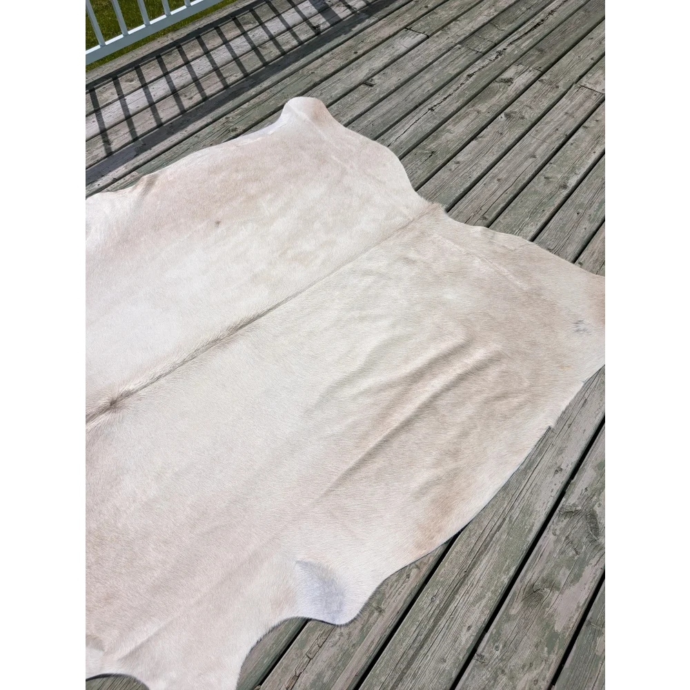 Large white natural cowhide rug with soft texture and subtle tones from angus oliver t