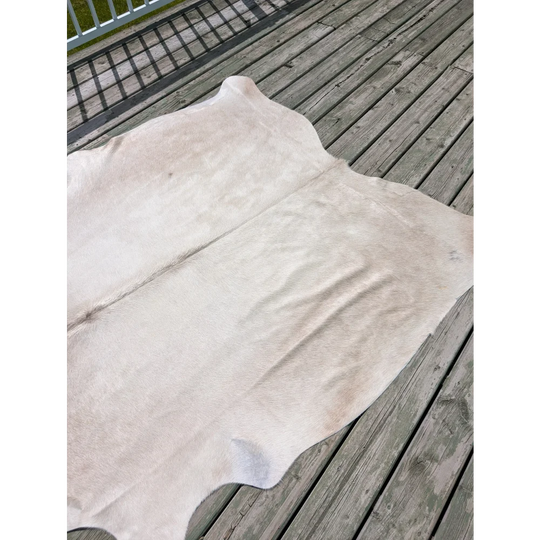 Large white natural cowhide rug with soft texture and subtle tones from angus oliver t