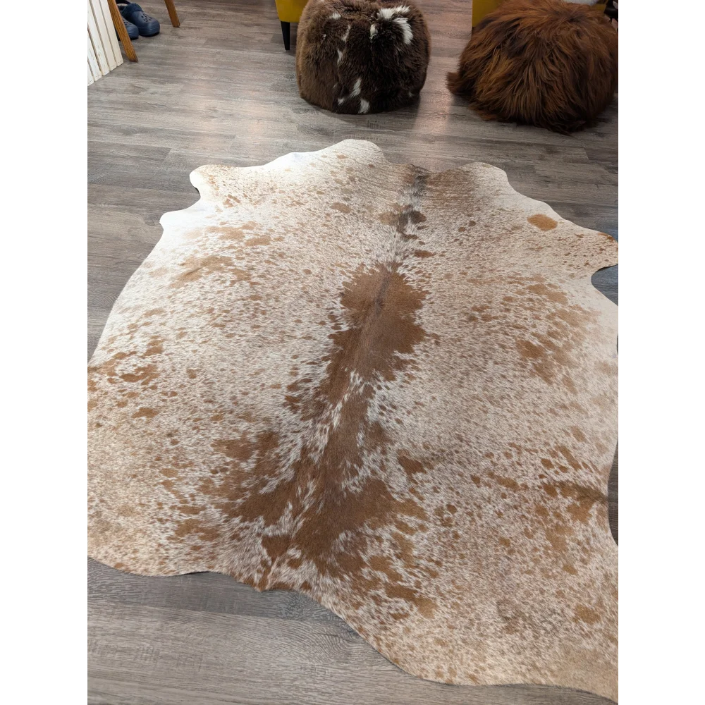 Large cowhide angus oliver cowhide rug with natural white and brown speckled pattern and irregular edges