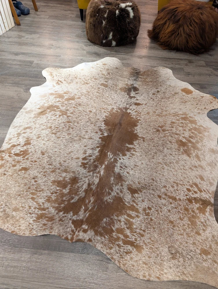 Large cowhide angus oliver cowhide rug with natural white and brown speckled pattern and irregular edges