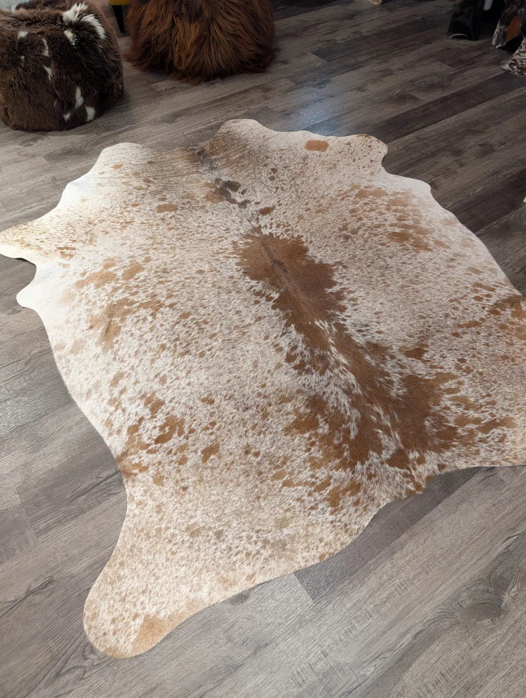 Large cowhide rug angus oliver with white and brown speckled natural tones and irregular edges 72 by 62 inches