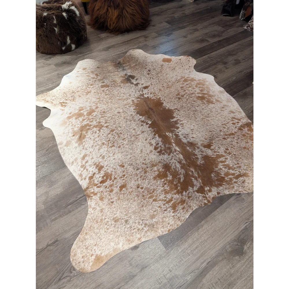 Large cowhide rug angus oliver with white and brown speckled natural tones and irregular edges 72 by 62 inches