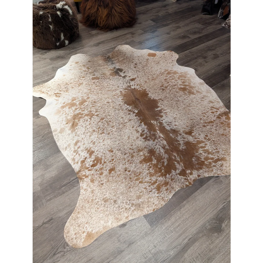 Large cowhide rug angus oliver with white and brown speckled natural tones and irregular edges 72 by 62 inches