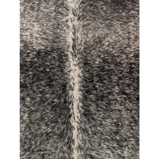 T22 large cowhide rug 67 x 73 with black and white speckles and a lighter stripe from angus oliver