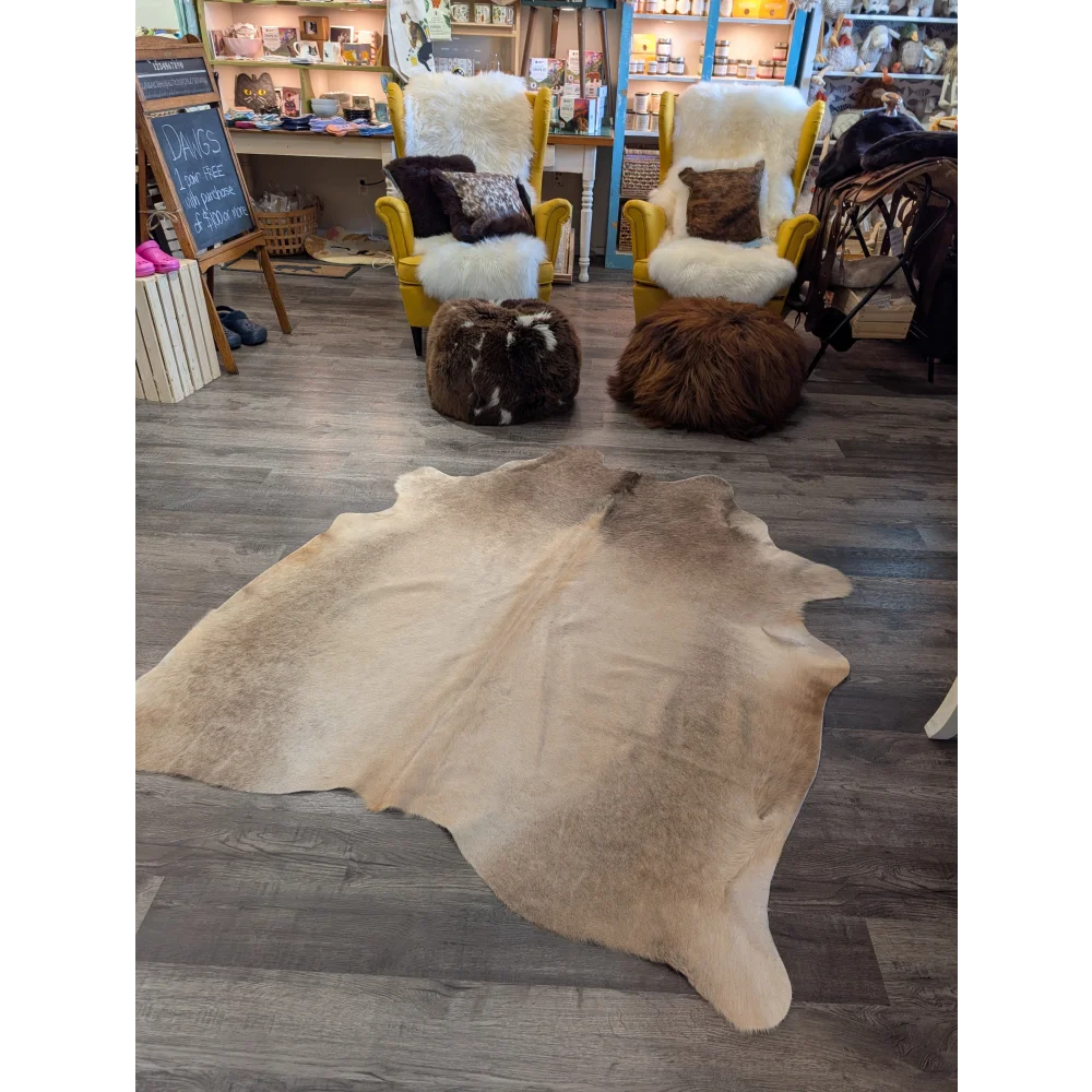 Natural tan large cowhide rug with soft textured surface and irregular edges from angus oliver t23 71 x 62