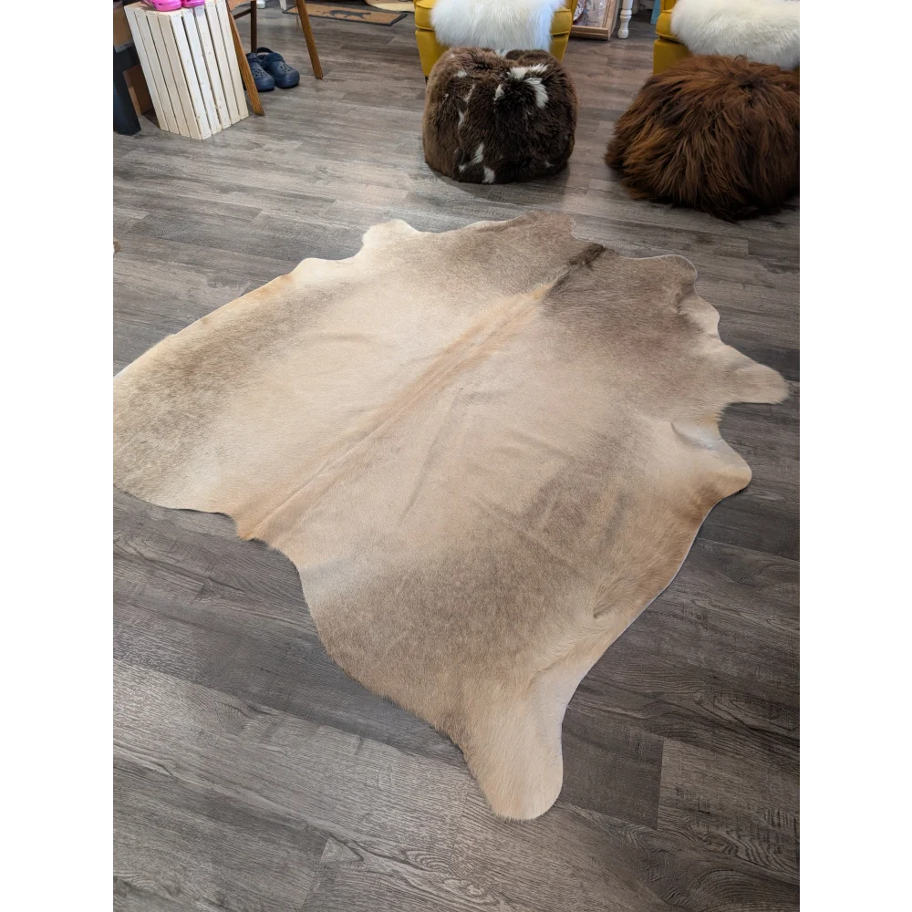 Large cowhide rug t23 in natural tan and beige with soft textured surface by angus oliver