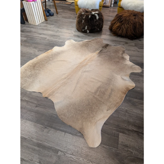 Large cowhide rug t23 in natural tan and beige with soft textured surface by angus oliver