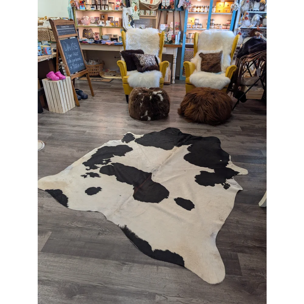 Large cowhide rug angus oliver with black and white natural irregular patches on a creamy base 67.5 by 64 inches