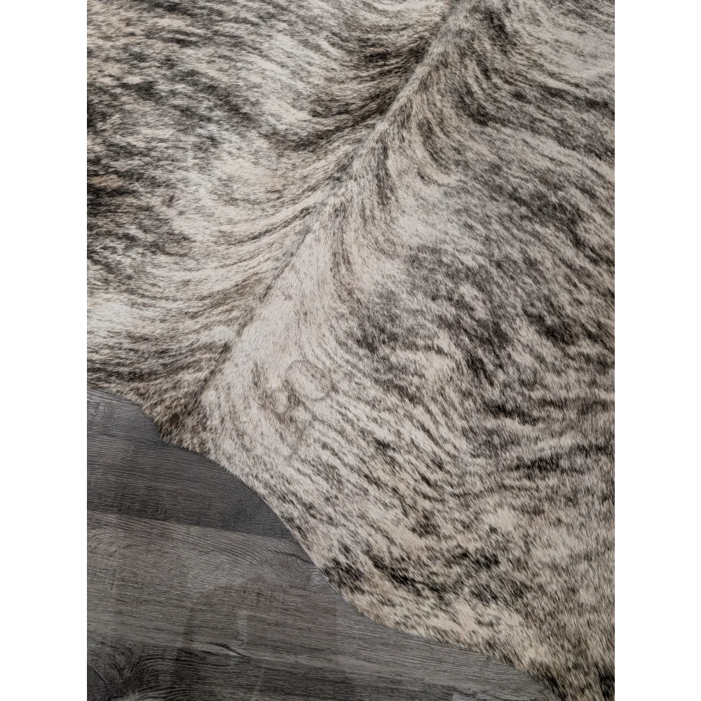 T26 large cowhide rug by angus oliver with plush black and white mottled fur measures 68 by 63 inches