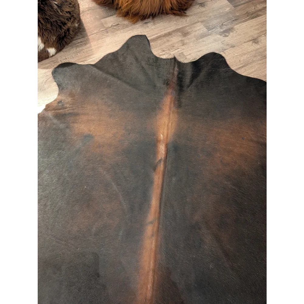 Large angus oliver cowhide rug in dark brown and black with a natural irregular edge perfect for home decor