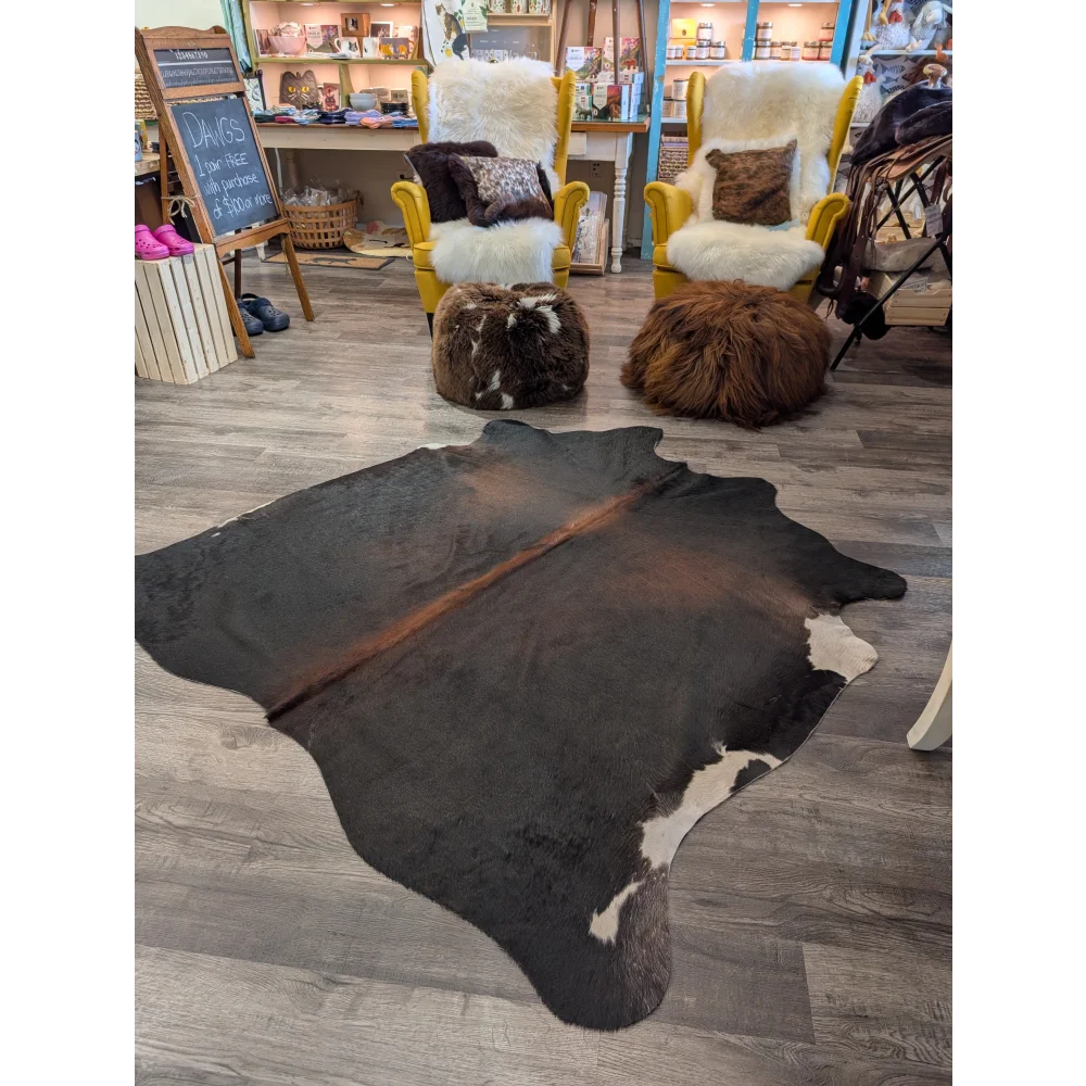 Large cowhide rug t27 with natural black and white angus oliver hide and a brown stripe down the center