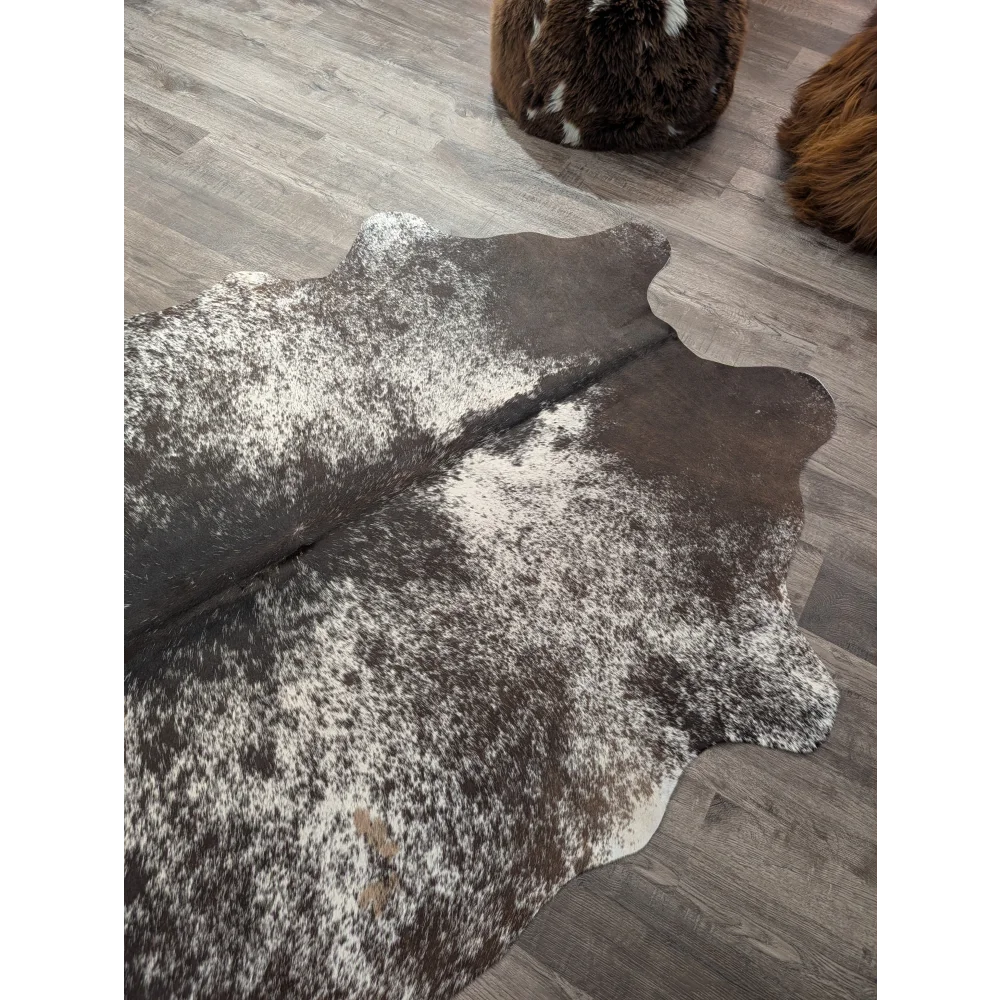 Brown and white speckled large cowhide rug with natural edges perfect for stylish home decor by angus oliver