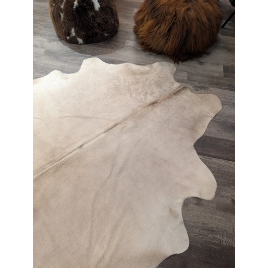 Beige angus oliver large cowhide rug with natural edges and soft textured surface perfect for cozy spaces
