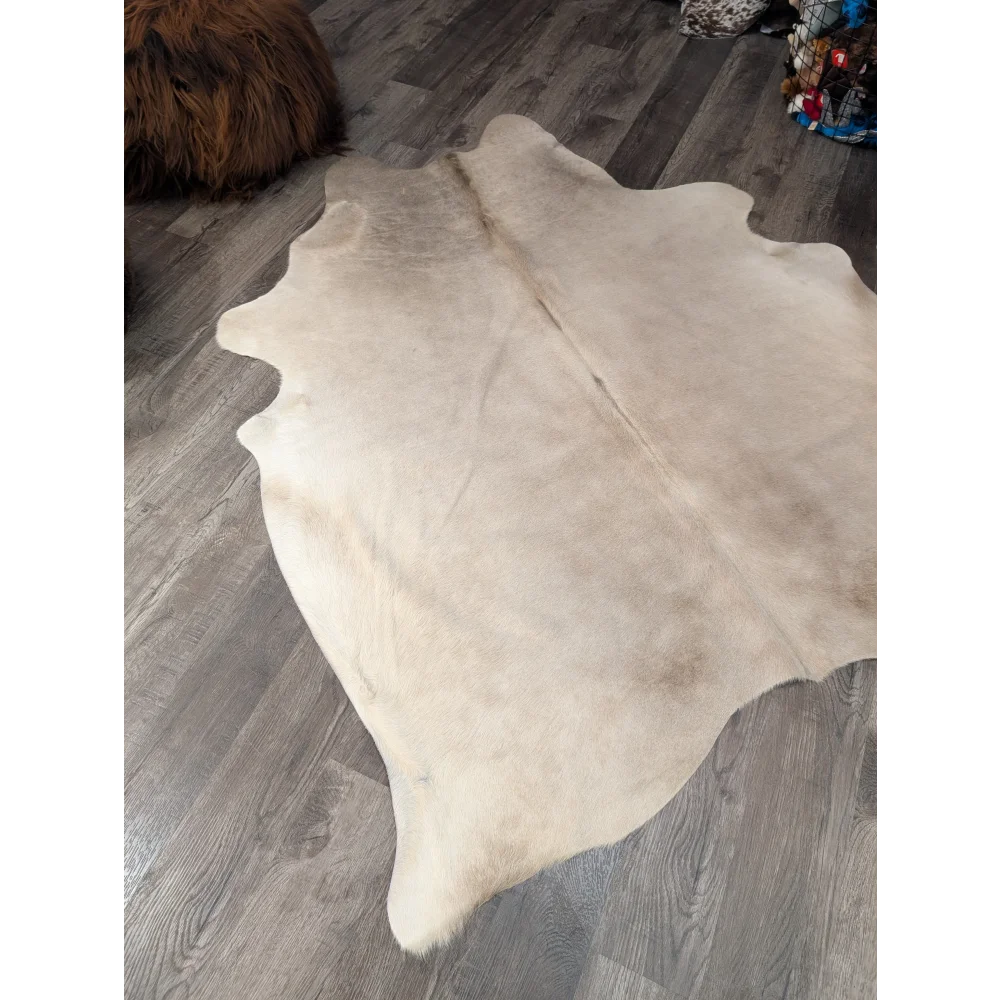 Large cowhide rug angus oliver in natural tones with subtle brown edges soft textured surface 72 x 61 inches