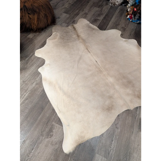 Large cowhide rug angus oliver in natural tones with subtle brown edges soft textured surface 72 x 61 inches