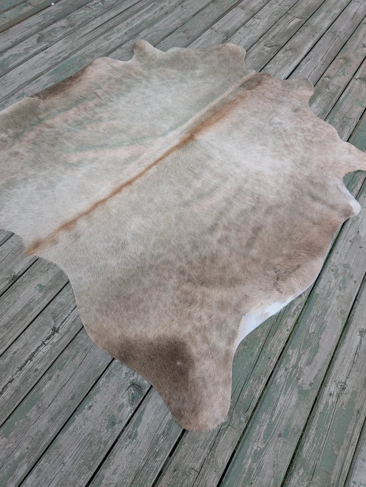 T3 66.5 x 62 large cowhide rug with unique characteristics in natural tones and subtle brownish gray hues