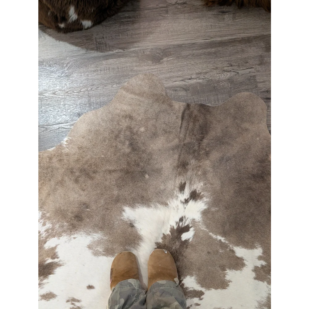 Large angus oliver cowhide rug in brown and white with natural irregular pattern perfect for living room decor