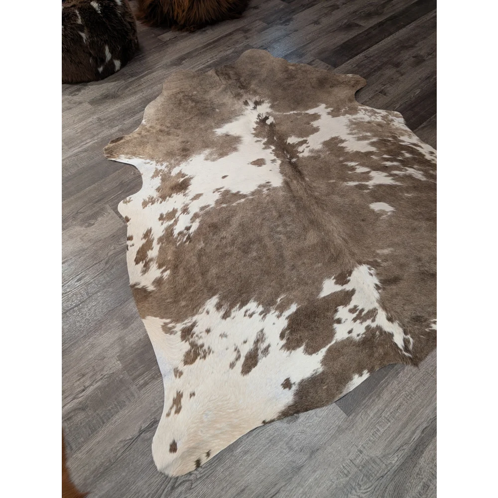 Brown and white large cowhide rug with natural fur texture perfect for stylish decor by angus oliver