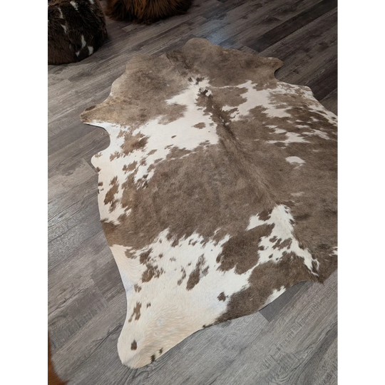 Brown and white large cowhide rug with natural fur texture perfect for stylish decor by angus oliver