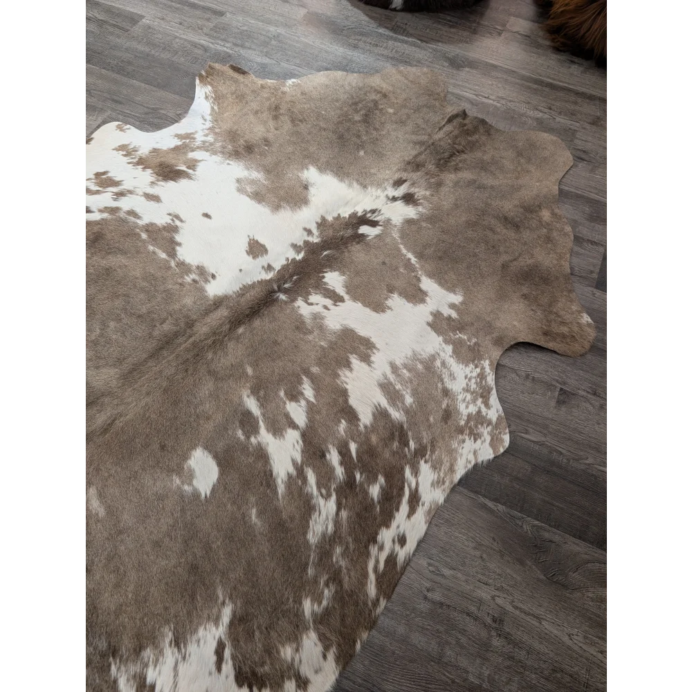 Brown and white large cowhide rug with natural fur texture perfect for stylish home decor angus oliver t30 74 x 60