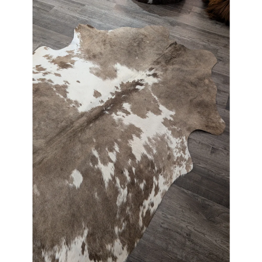Brown and white large cowhide rug with natural fur texture perfect for stylish home decor angus oliver t30 74 x 60
