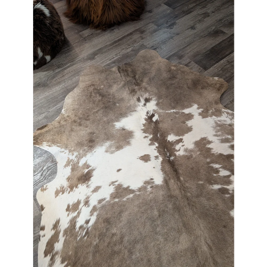 Brown and white large cowhide rug with natural irregular patterns perfect for stylish floors angus oliver t30 74x60