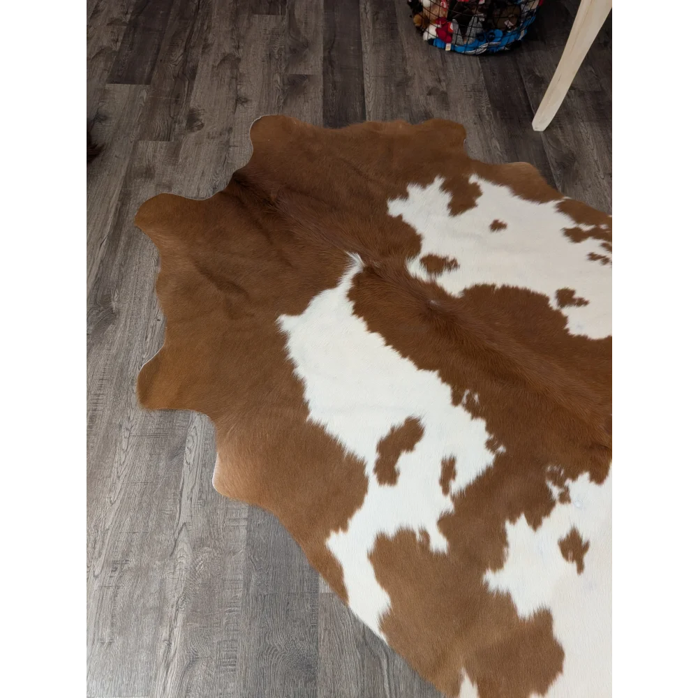 Large angus oliver cowhide rug in brown and white with natural fur texture perfect for stylish floor decor