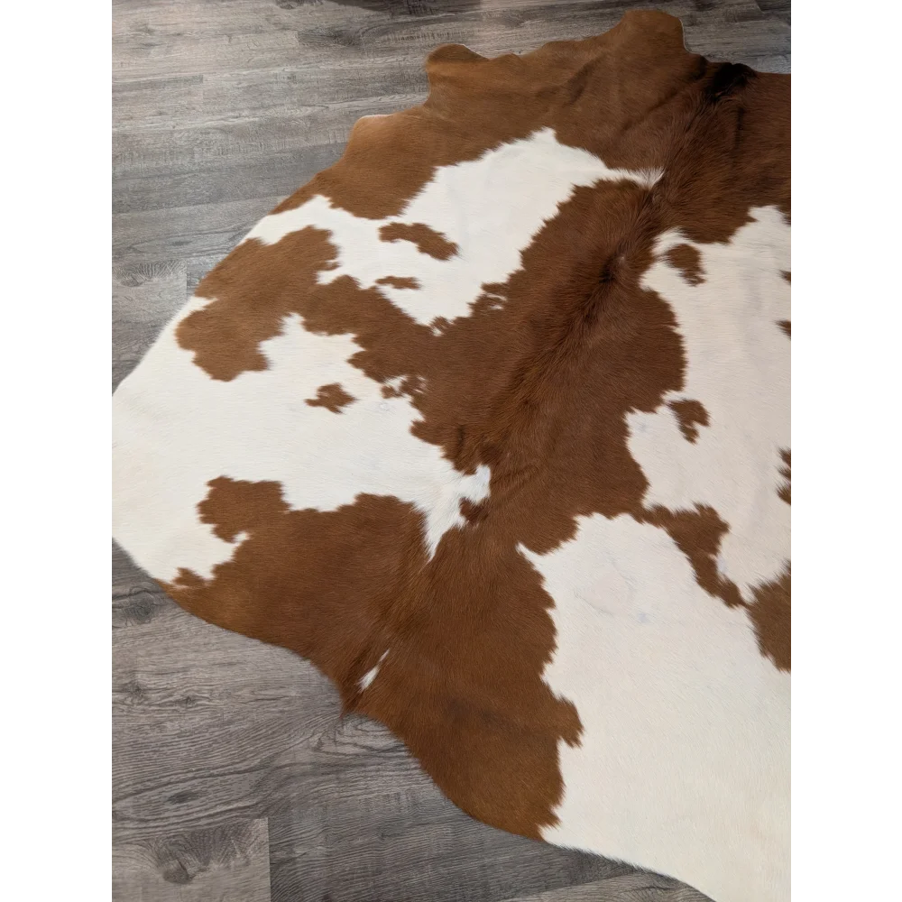 Brown and white large cowhide rug with natural fur texture perfect for stylish home decor from angus oliver