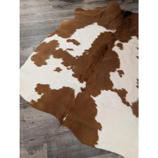 Brown and white large cowhide rug with natural fur texture perfect for stylish home decor from angus oliver
