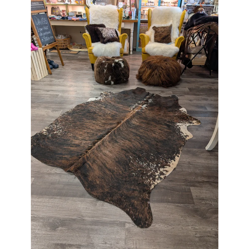 Large brown and white cowhide rug with natural irregular patterns perfect for angus oliver style spaces