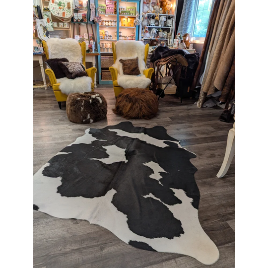 Large black and white cowhide rug with natural irregular patches in 73.5 by 64 angus oliver t33 model