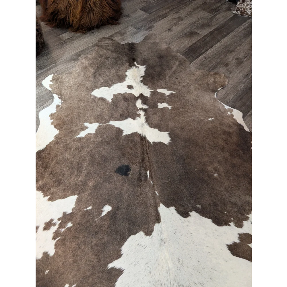 Large brown and white cowhide rug with natural fur texture perfect for stylish home decor angus oliver t34 79 x 67